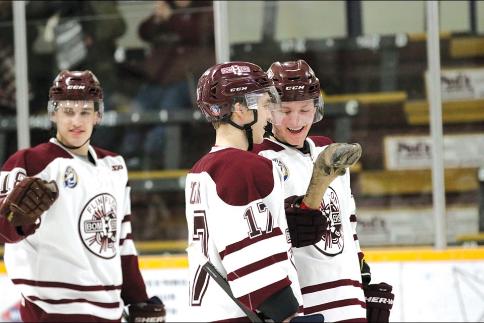 Flin Flon Bombers Chrystopher Collin and Brandson Hein hold up the treasured moose leg after the Bombers' 3-2 win over the top-ranked Nipawin Hawks. - PHOTO BY KELLY JACOBSON