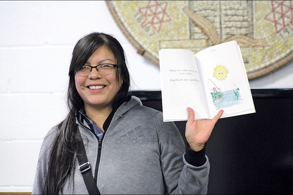 Author Dhedra Dumas reads parts of her new children's book, Water is Life: Iyako Nipiy Pimatisiwin to the crowd at the Flin Flon Public Library on Feb. 15. - PHOTO BY ERIC WESTHAVER