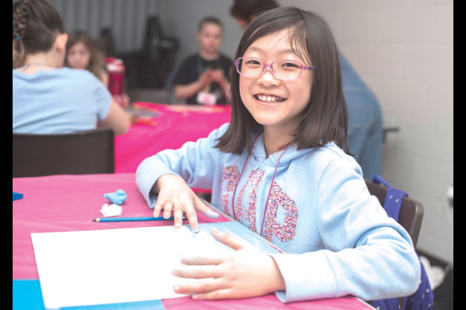 Olivia Lee smiles during her early morning plasticine art class on Feb. 20.
