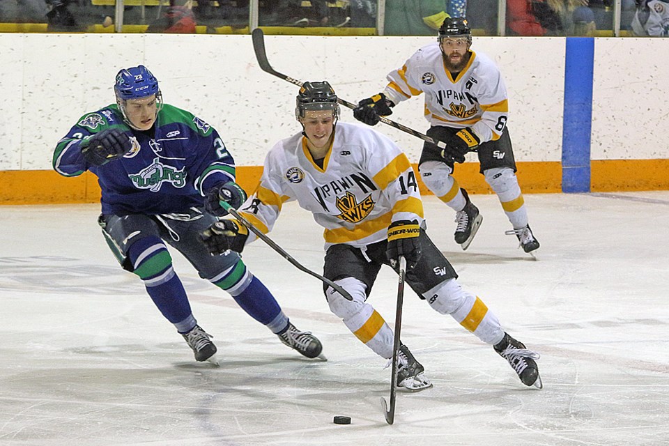 Kenzie Arnold of the Hawks, centre, prepares to shoot as Boedy Donald of the Mustangs comes to take the puck during the game in Nipawin March 2. Coming from behind is Michael Grant of the Hawks. Review Photo/Devan C. Tasa