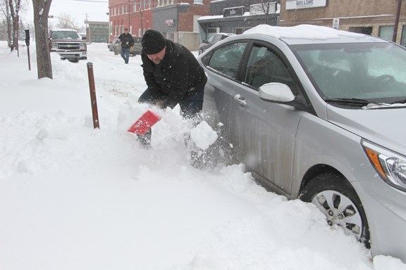 The dump of snow that blanketed Yorkton over the weekend meant many people throughout the city had to dig out their vehicles both going to and going home from work. Yorkton This Week staff were stuck dealing with the white stuff like everyone else, as our own Sean Mott had to dig out his car on Third Ave.