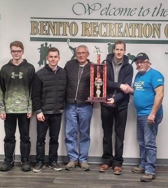 Winners of the first event of the Benito bonspiel, from left, were: Karter Meyn, lead; Carter Watkins, second; Marty Anderson, third, and Neal Watkins, skip. The J.A. Memorial Trophy was presented by Tom Lyons.