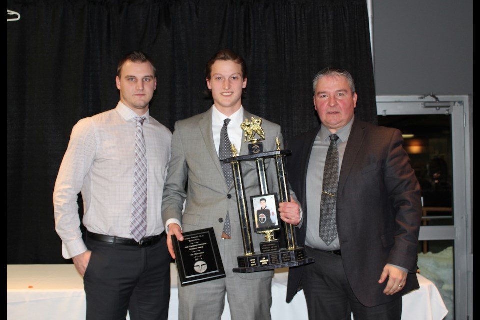 The Coaches Award, the The Josh Campbell Memorial Trophy was presented to Joe Marcouiller, centre, by Terrier head coach Mat Hehr, left and assistant coach Scott Musqua.