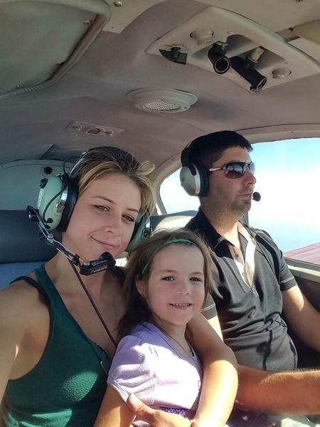 Ashley Bourgeault with her daughter Hayley on her lap, and pilot Dominic Neron were photographed inside his plane.