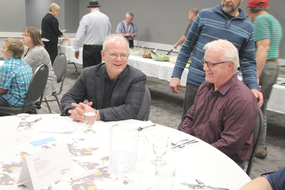 Jim Cornelius, Executive Director of the Canadian Foodgrains Bank speaks to Michael Moors at the Room at the Table event, held at the Gallagher Centre.