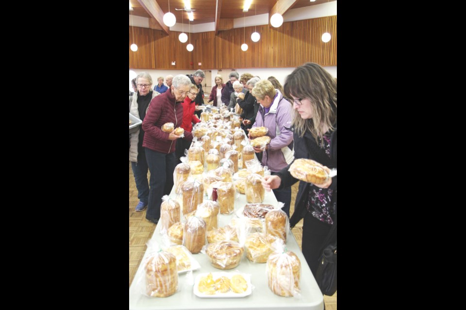 The Ukrainian Catholic Women’s League at St. Mary’s got people ready for Easter with their annual bake sale. Breads, perogies, cabbage rolls, butter lambs and Easter Eggs were all on offer. Verna Moroz decorated the eggs, while the assembled crowd quickly cleaned off the table.