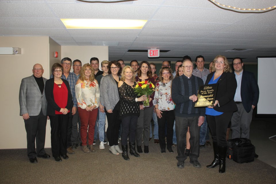 The Fornwald family accepts the Farm Family of the Year Award from Estevan MLA Lori Carr on Tuesday night during the Estevan Farmers' Appreciation Evening.