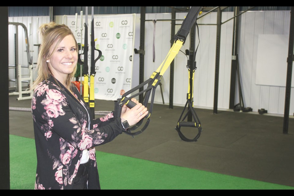 Brady Johnson, pictured here demonstrating exercise equipment at Encompass Fitness Studio, has been nominated for a YWCA Regina's Nutrien Women of Distinction Award in the Contribution to a Rural Community category. File photo
