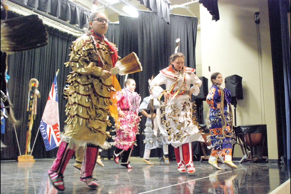 Performers from Indigenous Ensemble perform the jingle dress dance during the International Day for the Elimination of Racial Discrimination event on March 28 at Humboldt Public School. Over 650 students came from across Horizon School Division to learn about Indigenous culture with 45 dancers and 3 singers performing for the students. Donald Speidel with Indigenous Ensemble also told the students how the dances are significant in indigenous culture. photo by Becky Zimmer