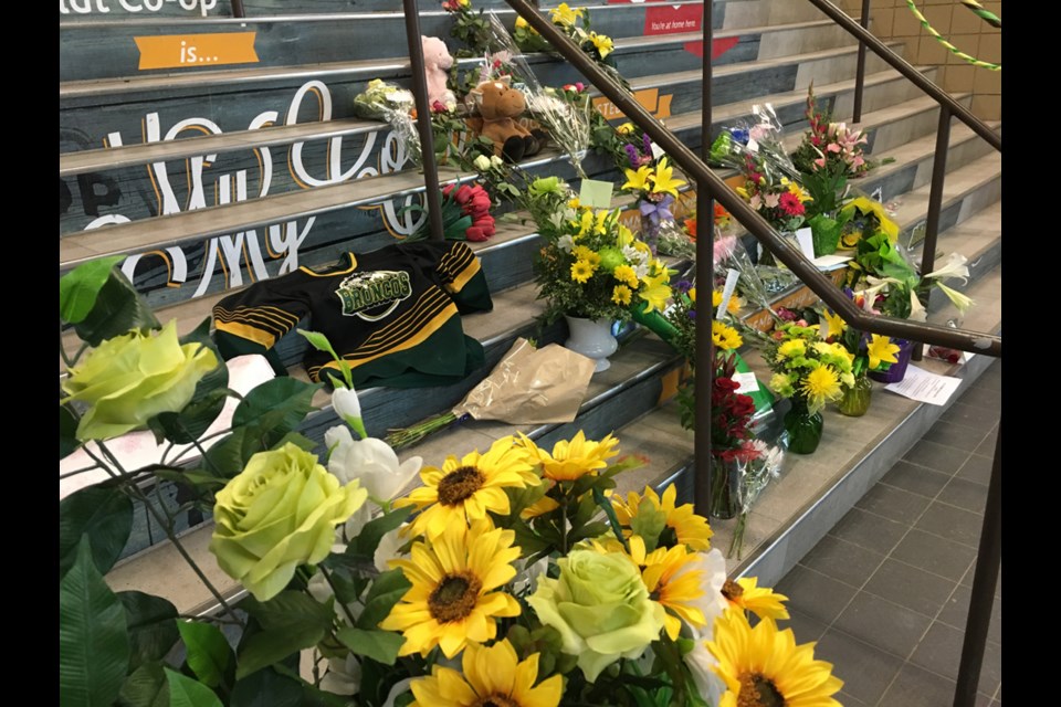 Flowers lined the stairs at the Elgar Petersen Arena on April 7 as a memorial was set up to honour the victims of the April 6 accident that claimed the lives of 15 members of the club. The remaining 14 passengers on board the bus were injured, with some being in critical condition.