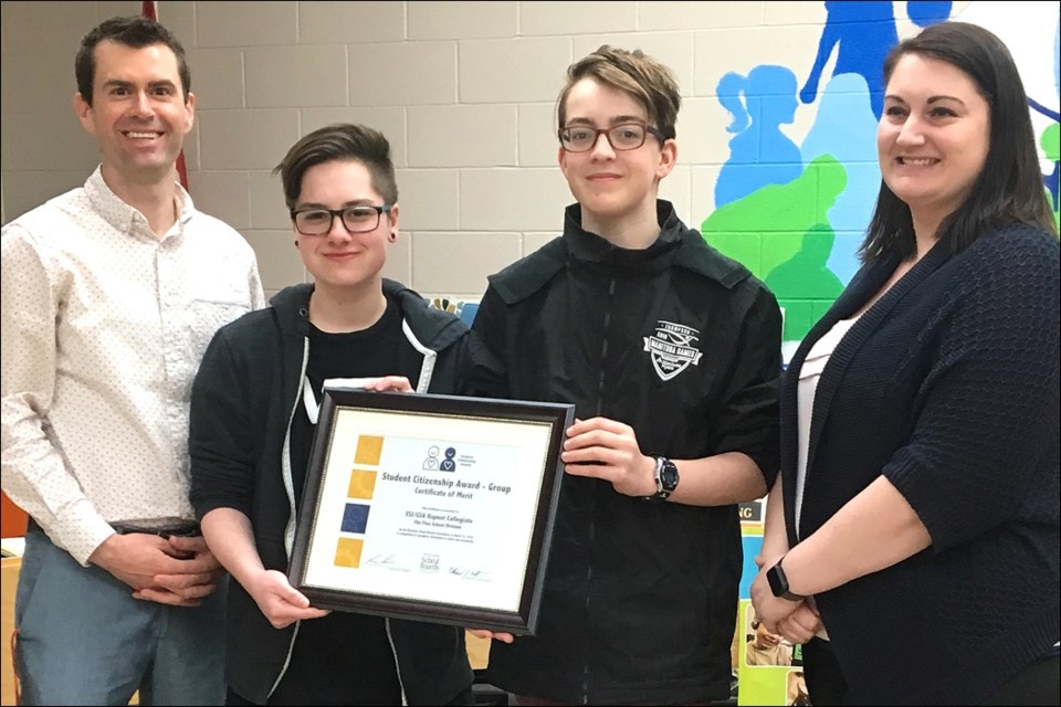 Hapnot teacher Daniel Dillon and students Andy Richard and Eli Plamondon (from left) receive a certificate of merit from the Manitoba School Boards Association on behalf of the Hapnot Equality Social Justice – Gay Straight Alliance from Flin Flon School Division trustee Leslie Fernandes (right). - PHOTO BY CYNTHIA BIGRIGG