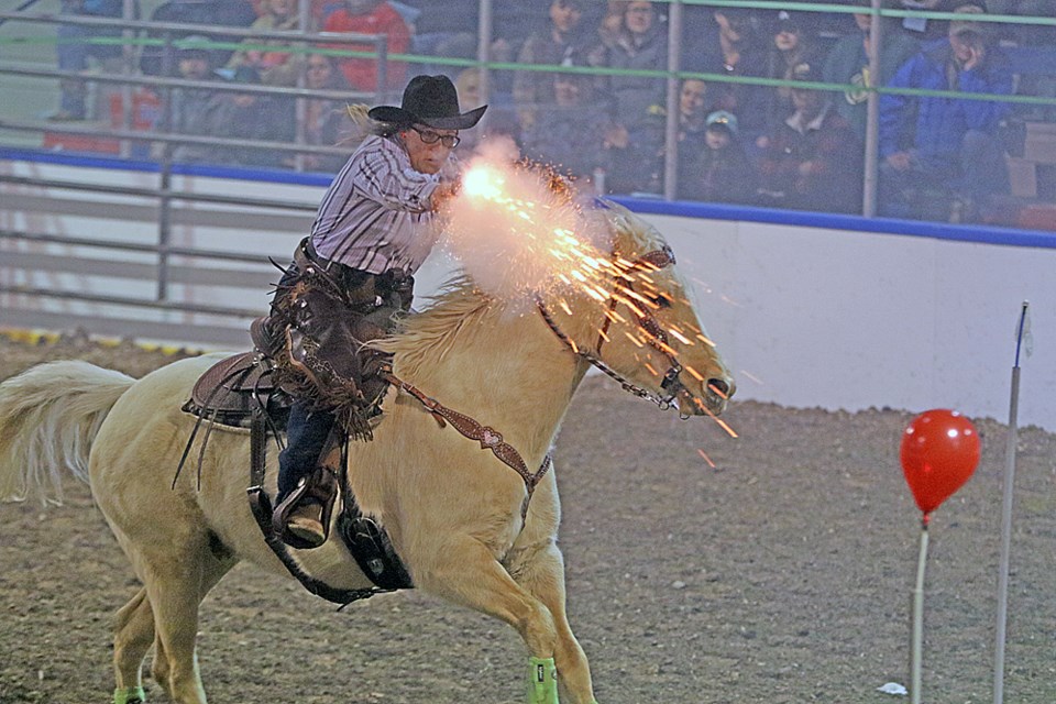 Kristen Wiens shoots at a balloon during a cowboy mounted shooting demonstration at the Tisdale Rambler Rodeo April 7. Photo by Devan C. Tasa