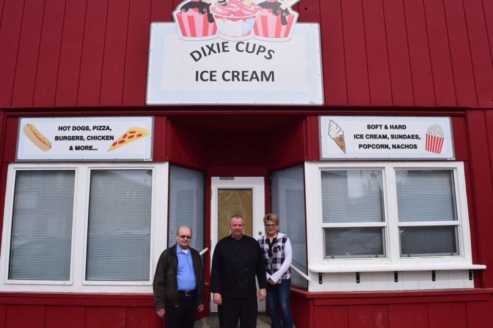 The former Glass Door Jewelry store, on Kamsack’s main street, has been renovated and will re-open as Dixie Cups Ice Cream. At left, Matt Kutsak (owner), Kris Ferrill and Rhonda Rosset (employees) stood on the step of the building that some residents may remember as Percy’s Elite Confectionary.