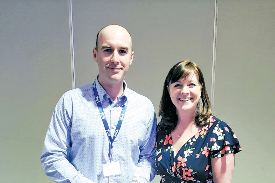 Paul Raycroft received the Award of Merit from Jane Rooney during the Saskatchewan Business Teachers’ Association Conference last week following the Business Case Study competition. Raycroft was given the award for his years of dedication in teaching financial literacy, including his efforts at Humboldt Collegiate Institute. photo courtesy of Financial Consumer Agency of Canada Twitter