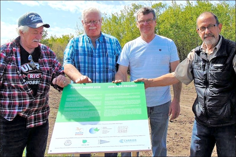TREE partners Mel Deagnon and Al Sorenson (Aspen Innovation Park), Serge Gauvin (Charlevoix Biosphere Reserve) and Peter Kingsmill (Redberry Lake Biosphere) at a tree planting event May 15 near Hafford.