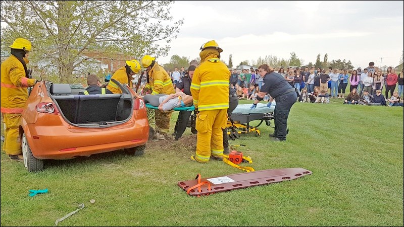 Emma Baker, victim, was the last one evacuated from a mock accident scene. The situation required all hands on deck from responding rescue forces as there was the potential of a spinal injury. Fellow students got a first-hand glimpse of the work and trauma involved in responding to an accident. Photos by Sherri Solomko