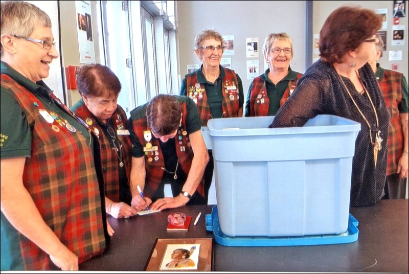 Raffle Draw — Heather Anderson, Dekker Centre office supervisor, makes the draw for the winner of North Battleford Bonadventure Lions Club raffle. Pictured with her are Lions Ellie Mae Bishop, Naty Keys, Joyce Ruzesky, Linda Laycock, Yvonne Nyholt and Gwen Laughlin. The winners of the draw were: $250 Dekker Centre gift certificate - Neo and Vix Legario;  $175 Dekker Centre gift certificate - Nancy Wappel; petit point picture - Deb Dyck. Photo submitted