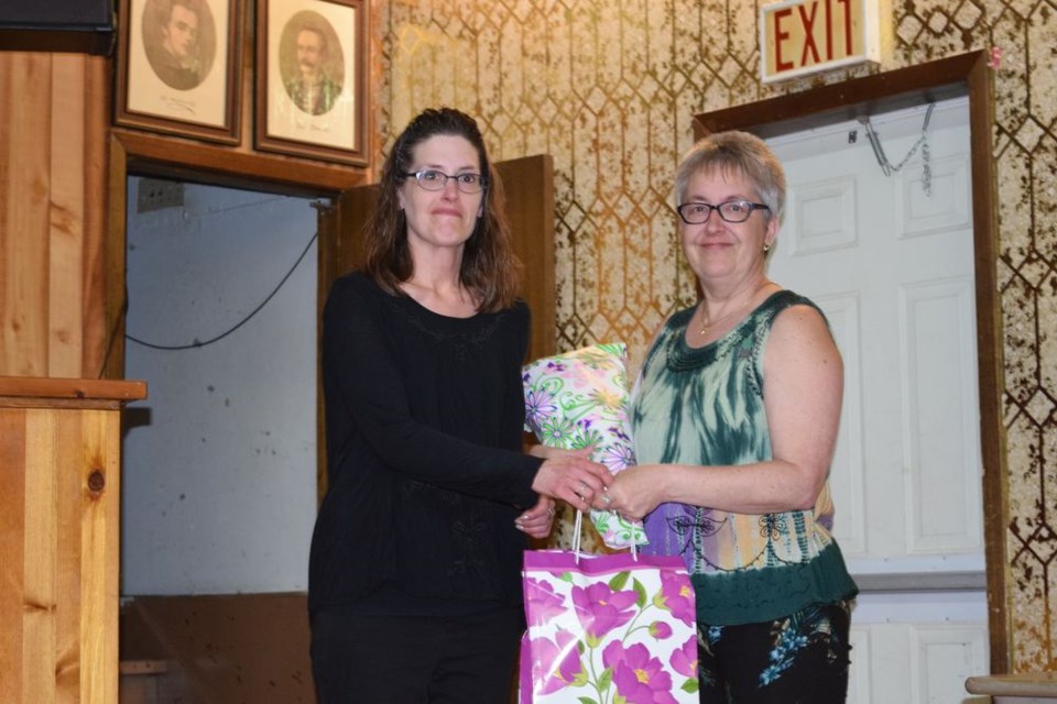 Alyssa Lukey, incoming general leader (left), made a presentation to Bev Spearman, outgoing general leader, in recognition of her eight years of service at the Canora Homecraft 4-H Club Achievement Day on May 12 at Rainbow Hall.