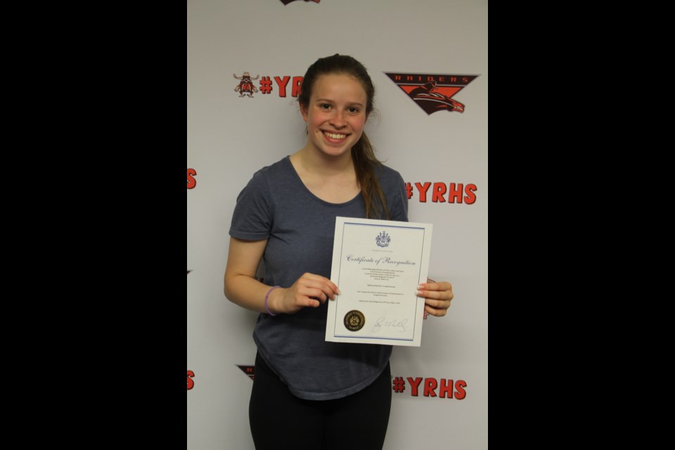 Aly Serray with the proclamation from the Government of Saskatchewan declaring June 6 as Walk and Roll Day in the province.