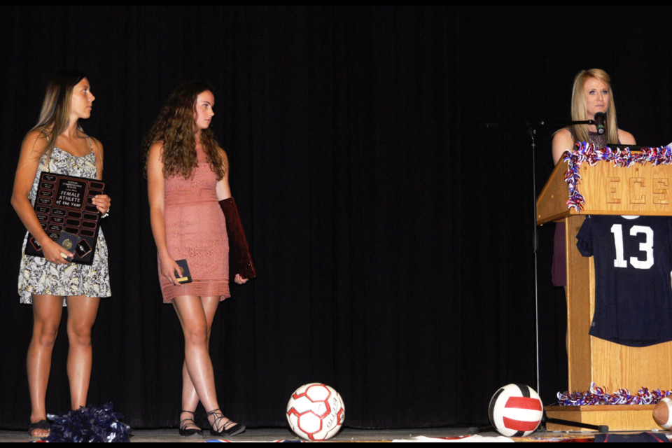 Tatiana Dutka, left, and Morgan Fichter, centre, listen to Jessie Smoliak talk about their accomplishments as co-winners of Estevan Comprehensive School's female athlete of the year Thursday night at the Comp