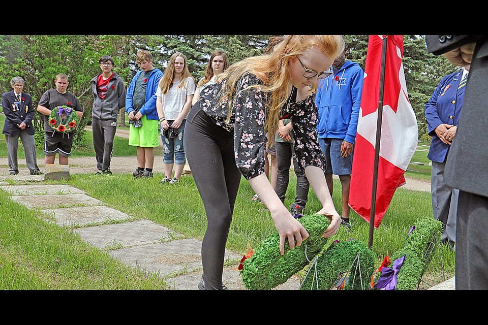 Grade 8 students from Nipawin’s LP Miller Comprehensive decorated the graves of veterans on the 74th anniversary of D-Day. Photo by Devan C. Tasa