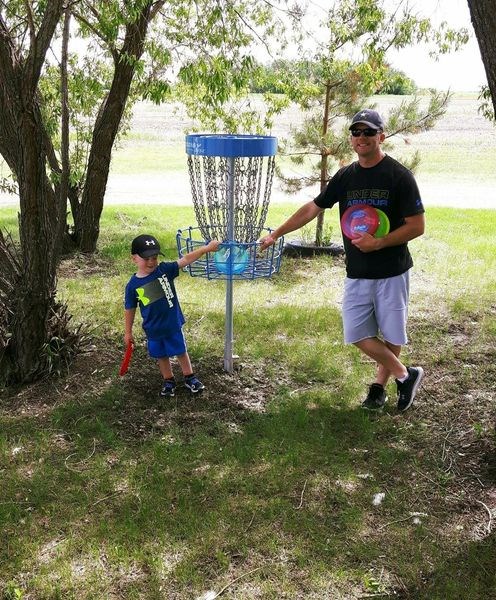 Emmett Kitchen and his father Kevin enjoyed playing the Kamsack Disc Golf Course located at the Kamsack Sportsgrounds. The course was installed last year, and recently the new baskets were installed by the town.