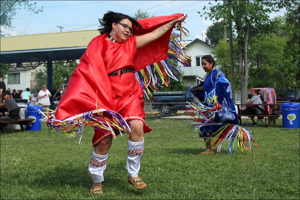 Natasha McDermott (left) and Hazel Colomb perform a round dance. - PHOTO BY CYNTHIA BIGRIGG