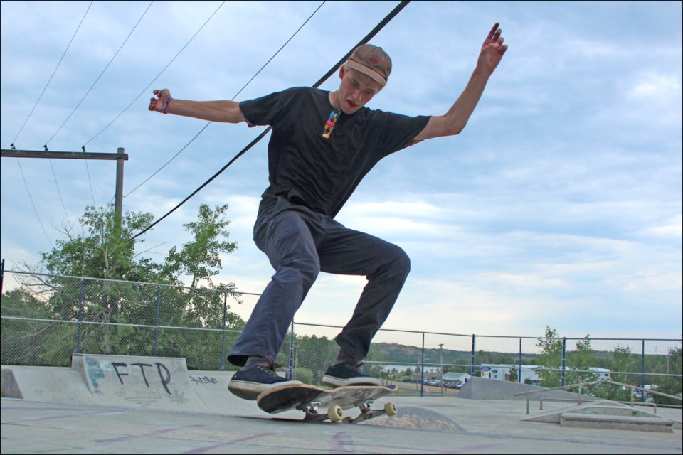 A crowd gathered at the Flin Flon Skate Park on June 19 for the Sk8 Skates northern demo tour. Fane Smeall of Sk8 Skates shows off his skills at the Flin Flon Skate Park during the demonstration. - PHOTO BY CYNTHIA BIGRIGG