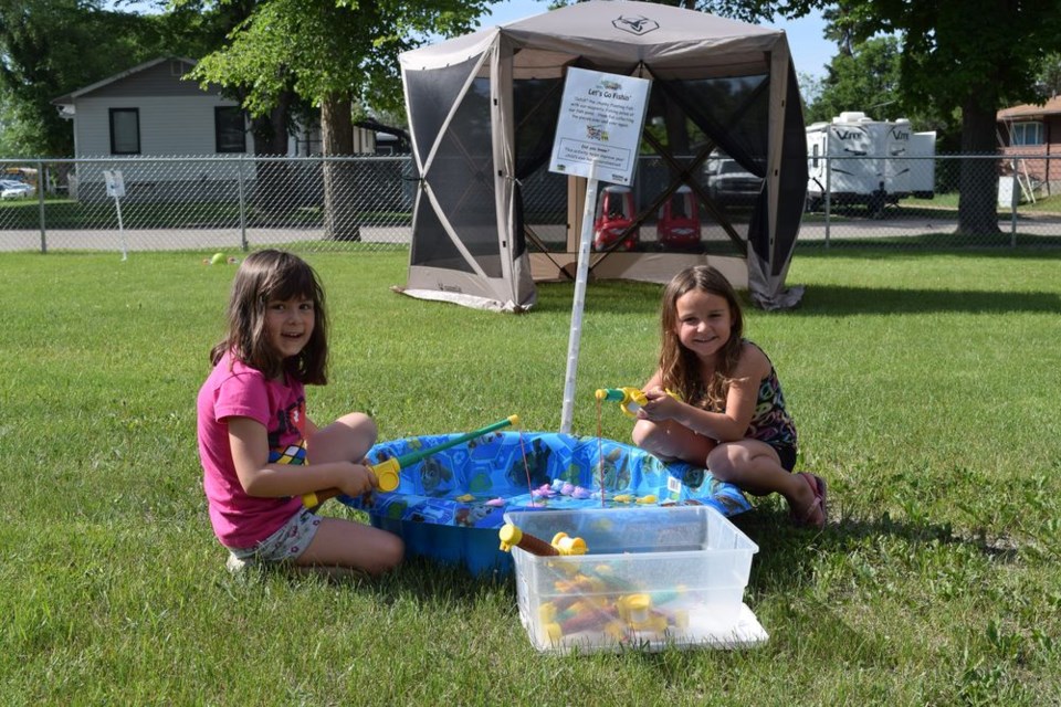 Five-year-olds Jael Norberg (left) and Hannah Dutchak came out to meet the Main Street Mobile on June 21 at Kids Korner in Canora, and played at the “Let’s go Fishin’” station, catching ‘fish’ with magnetic fishing poles.