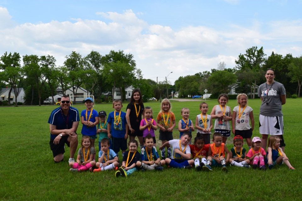 The soccer team, which held their final season game on June 19, from left were: (back) Kev Sumner (coach), Kacee Kitchen, Emmett Kitchen, Luke Walters, Summer Erhardt, Quinn Erhardt, Kayman Nikiforoff , Xander Gareau, Kaylum Semeniuk-Halliday, Isobella Marsh, Sophia Walters and Louise Sumner (coach), and (front) Maddison Derwores, Meesha Mokrydze, Oakley Dolman (dark blue t-shirt), Emmet Erhardt (blue shirt with white patches on shoulders), Archie Sumner, Mason Kash Bryant, Skylar Semeniuk-Halliday, Emmett Marsh, Karleigh Lambert and Esmie Sumner. Daniel Severight was unavailable for the photo.