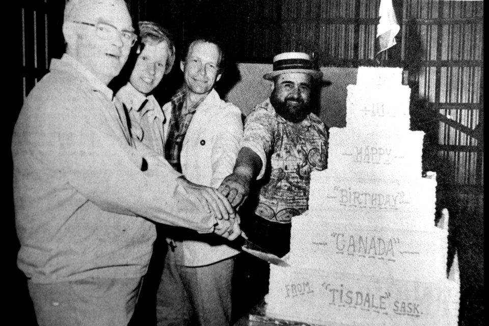 A four-foot birthday cake, topped by a Canadian flag, was cut when Canada's 111th birthday [in 1978] was just minutes old early Saturday morning. Participating in the ceremony which followed a dazzling fireworks display, were [left to right] Mayor Maurice Taylor, Chamber of Commerce President Bruce Maclennan, Mineral Resources Minister and Kelsey-Tisdale MLA Jack Messer and TUC'S Principal Larry Salamon. The week-long festivities leading to a five-hour program Friday evening at the fairgrounds was sponsored locally by the Chamber of Commerce with financial assistance from the Town of Tisdale and the federal government. Mr. Salamon was master of ceremonies for the stage show which was moved indoors because of unsettled weather.