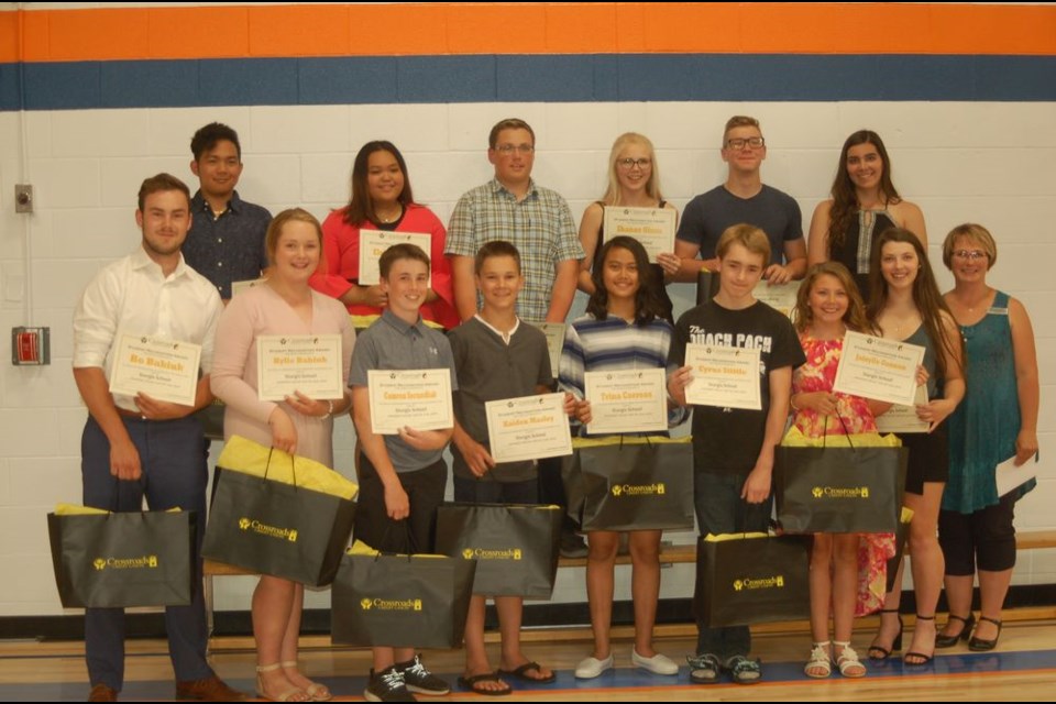 The Crossroads Credit Union recognized students at the Sturgis Composite High School on June 20. From left, were: (back row) JR Puyos, Eloisa Vicente, Shae Peterson, Shanae Olson, Knute Vallevand and Sierra Meroniuk and, (front) Bo Babiuk, Kylie Babiuk, Camron Secundiak, Kaiden Masley, Trina Correos, Cyrus Stittle, Jainylle Gagnon, Peyton Secundiak and Doreen Bochnuik, Crossroads Credit Union representative.