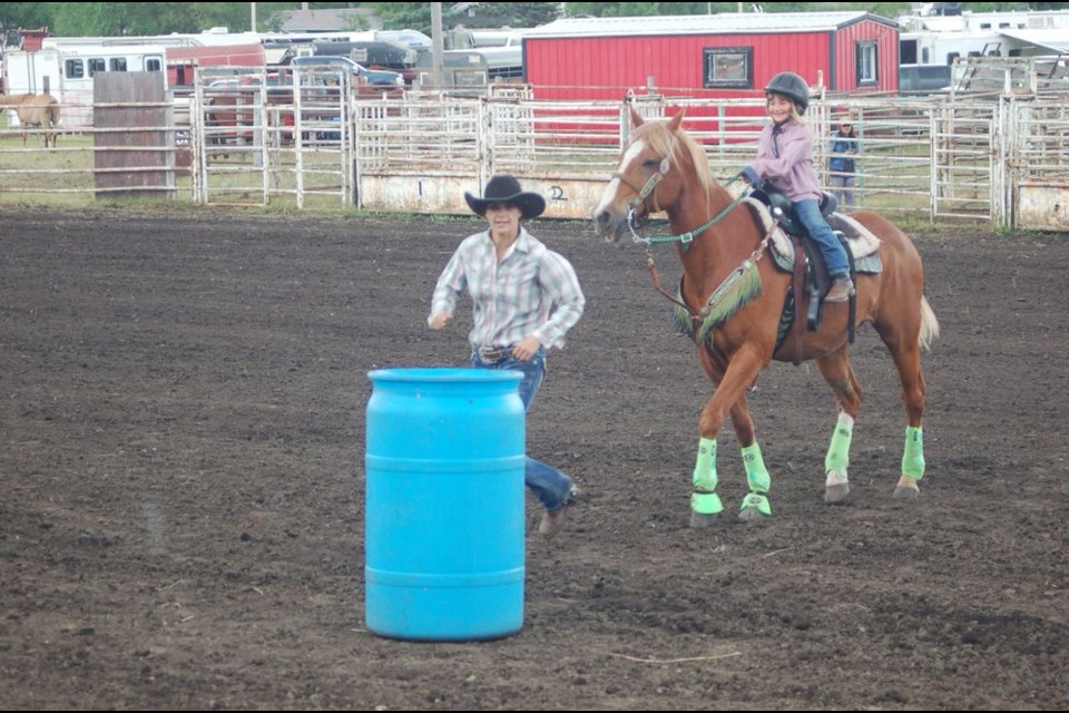 Ronnie Prekaski, left, encouraged her daughter Mercedes Lindholm, and her horse in the barrel event during the Etomaimie Valley Riders gymkhana event in Sturgis on June 24. They are both from Lintlaw.