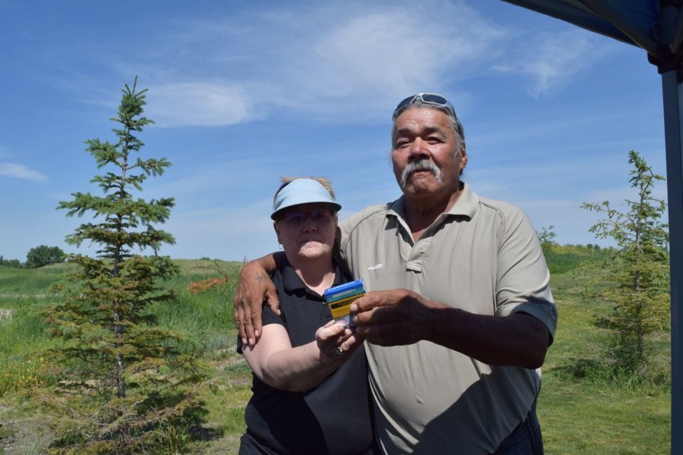 Kamsack Mayor Nancy Brunt passed a symbolic offering of tobacco to William Whitehawk at the National Indigenous Peoples Day celebration held at the Petro-Canada grounds.