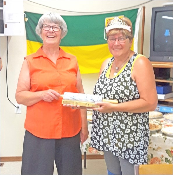 Norma Sherman presents "Rhubarb Ruby" Margaret Siegel with the first place rolling pin