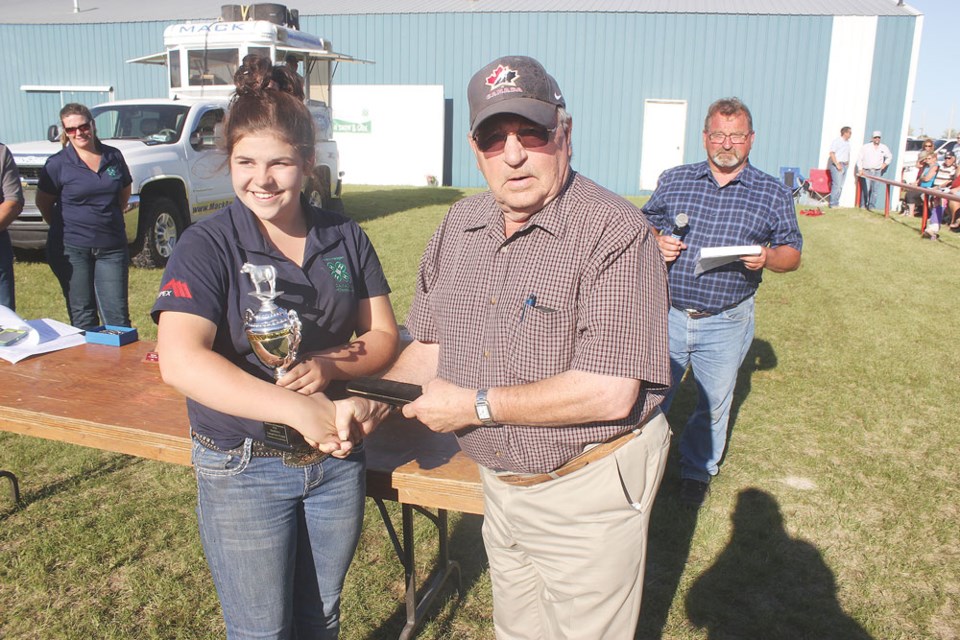 Casie Brokenshire, left, was presented with the award for the reserve champion steer from Ray Frehlick with Prairie Mud.