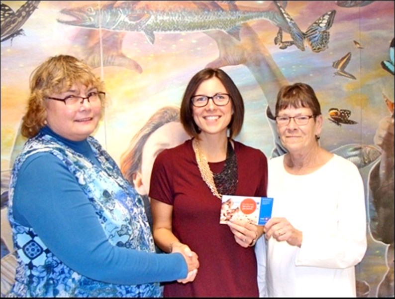 Nicole Combres, executive director of the Battlefords Boys and Girls Club, accepts a cheque in 2016. File photo