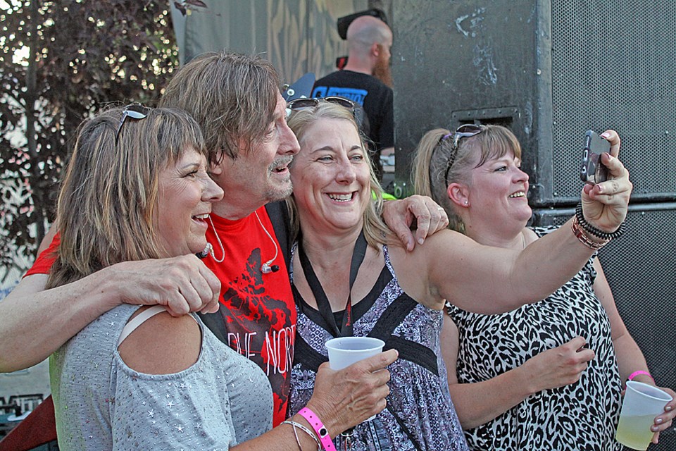 Nick Gilder poses with some fans at this year’s Rockin’ the Square. Him and his band, Sweeney Todd, opened the July 6 concert.Photo by Jessica R. Durling