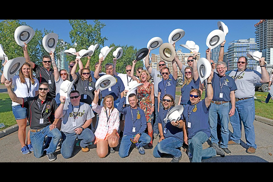 First responders from the Tisdale and other Northeast communities that responded to the Humboldt Broncos bus crash were invited to march in the Calgary Stampede parade. Here they pose with Premier Rachel Notley. Photo by Chris Schwarz/Government of Alberta