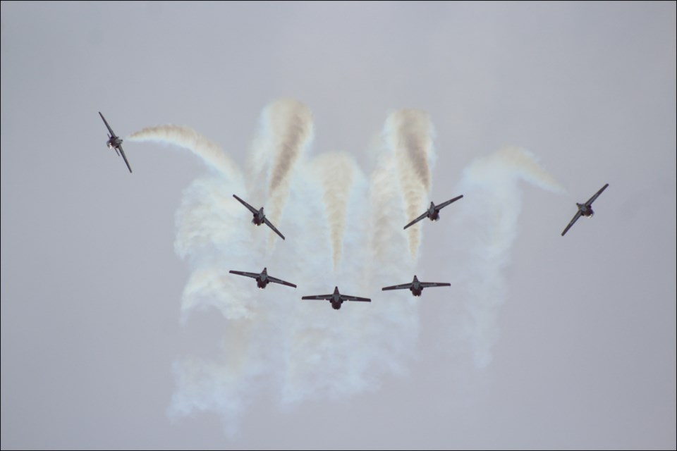 The Snowbirds aerobatics team zooms in and out of formation over Flin Flon Airport on July 11. - PHOTO BY ERIC WESTHAVER