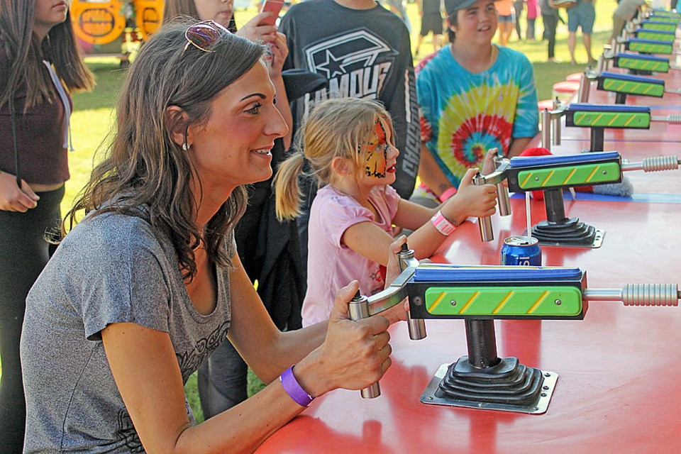 Charlie Ruzic (right) beats Julie Ruzic (left) at water guns. Photo by Jessica R. Durling