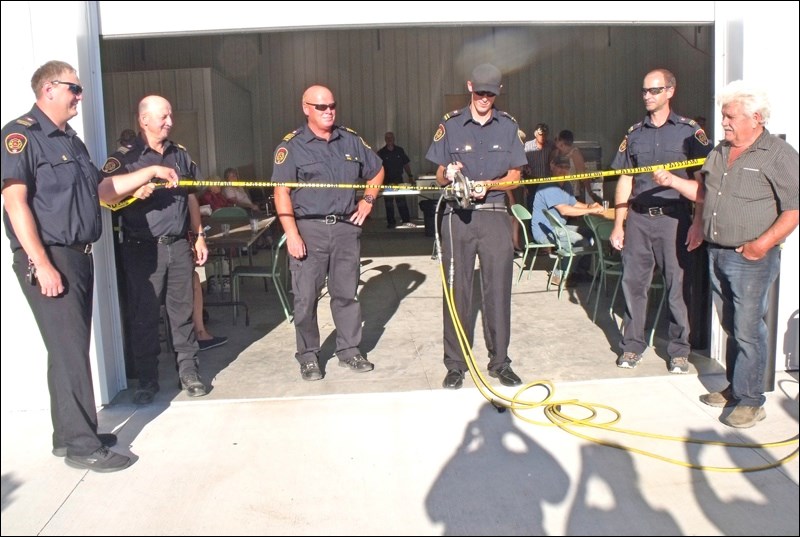 Participating in a ribbon cutting ceremony July 16, to officially open the Borden Fire Hall addition, are Jamie Brandrick, Ian Tracksell, Ian Wainwright, BJ Berg. Rob Schmidt and Ron Saunders. Photos by Lorraine Olinyk