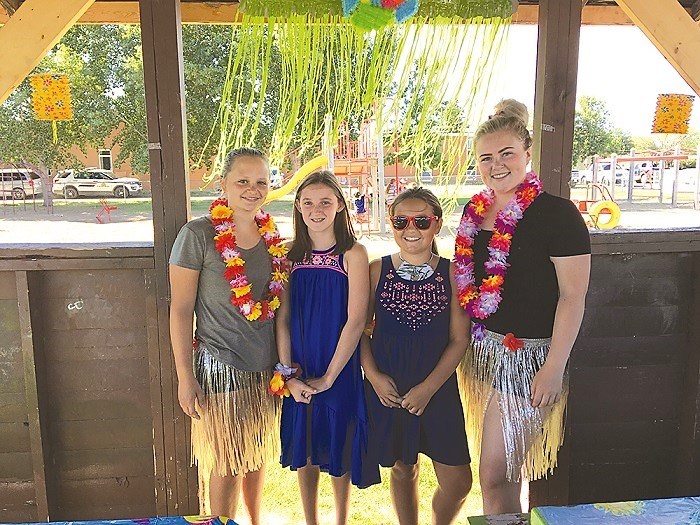 Summer Program Coordinators Emma Ingell (far left) and Courtney Clark (far right) were joined by Kylee Lemon and Cadence Knapik in putting on a fabulous luau for children in the Kinsmen Spray Park last Thursday.