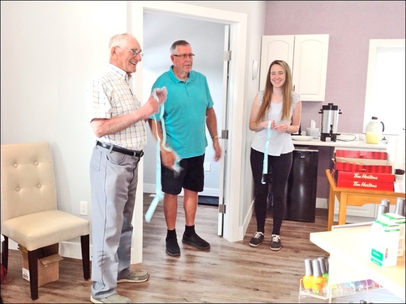 Walter Tait, Mayor John MacDonald and Meg Scorgie officially open Scorgie’s new esthetics shop.