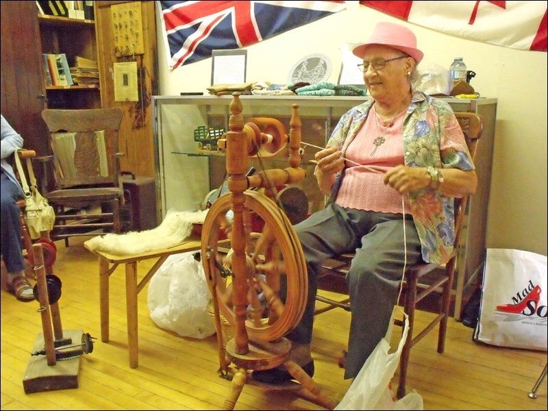 Annie Kostiuk of Saskatoon demonstrating the spinning wheel at the Borden Museum July 28. Photos by Lorraine Olinyk