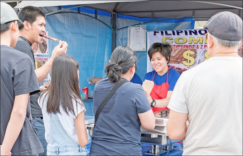 A customer enjoys satay.