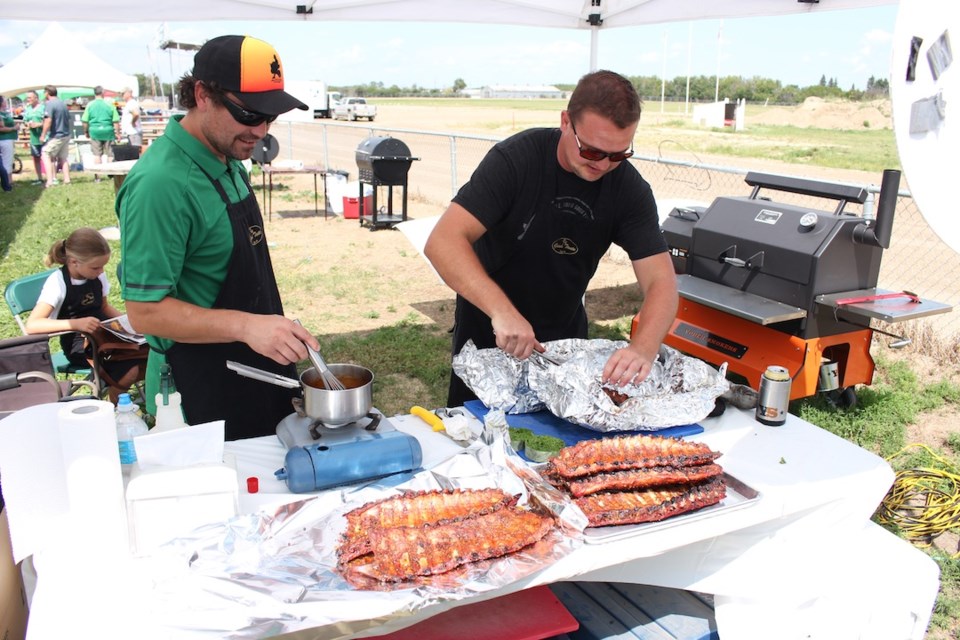 Jordan Hilderman, left and Jared Ruf work on the sauce and ribs which would win the amateur contest at this weekend’s Rhythm ‘n’ Ribs held in Yorkton.