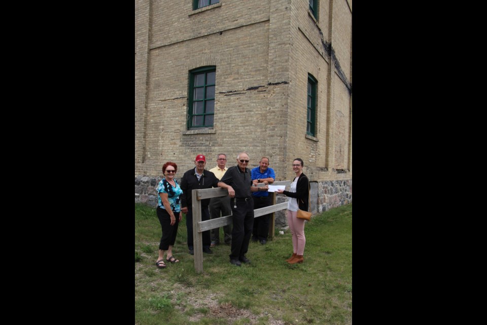 Gladys Krepakevich, Glenn Wiseman, Larry Pearen and Gene Krepakevich of the Yorkton Brick Mill Heritage Society, presented with a check from YBID, represented by Bruce Thurston, board member and Meagan Richards, chairperson.