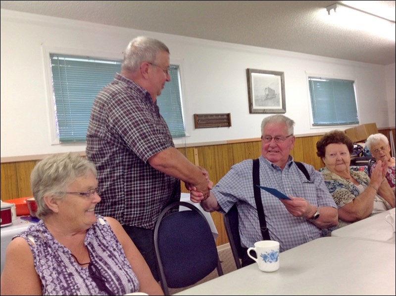 Bob Zurowsky expresses the appreciation of the Meota Hobby Band members for the contributions of founding member Martin Weber, who has retired from the band. Photos submitted by Lorna Pearson