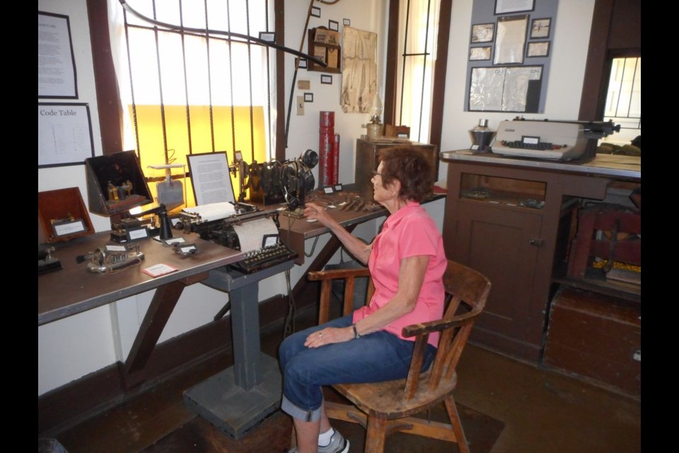 Olive Oakes was photographed as she sat at her father's old desk and shared fond memories of her father, Harold Oakes. Harold Oakes had served as the Sturgis train Station agent from 1943 to 1954.